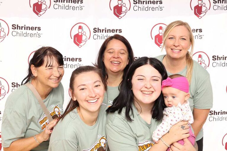 Five women and a baby smiling