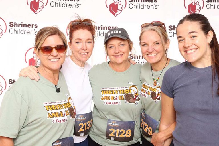 Group of five women smiling