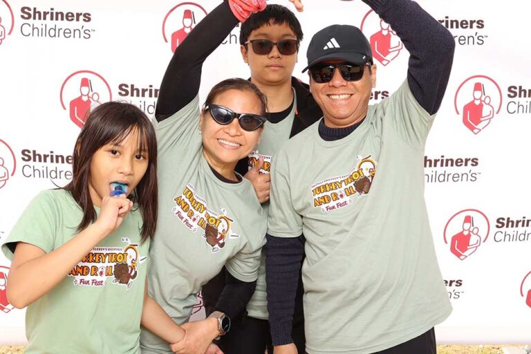 Man and woman with young man and young woman smiling