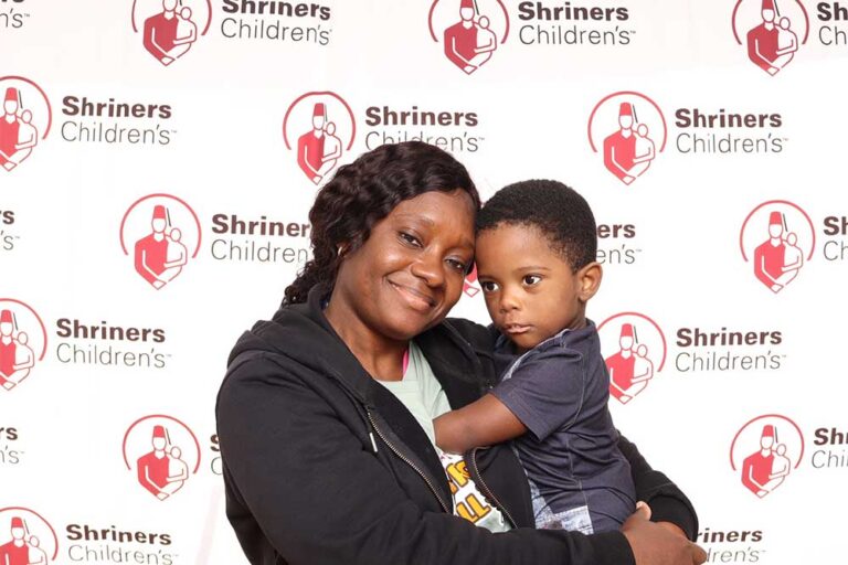 Woman holding a small child and smiling