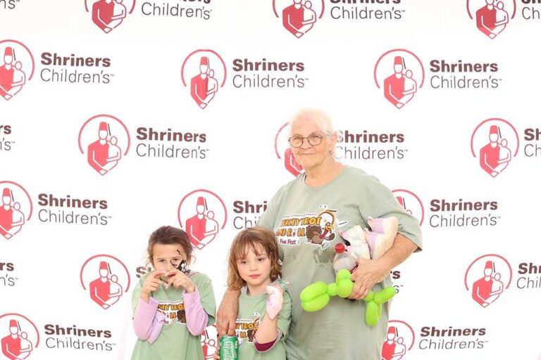 Older woman with two young children smiling