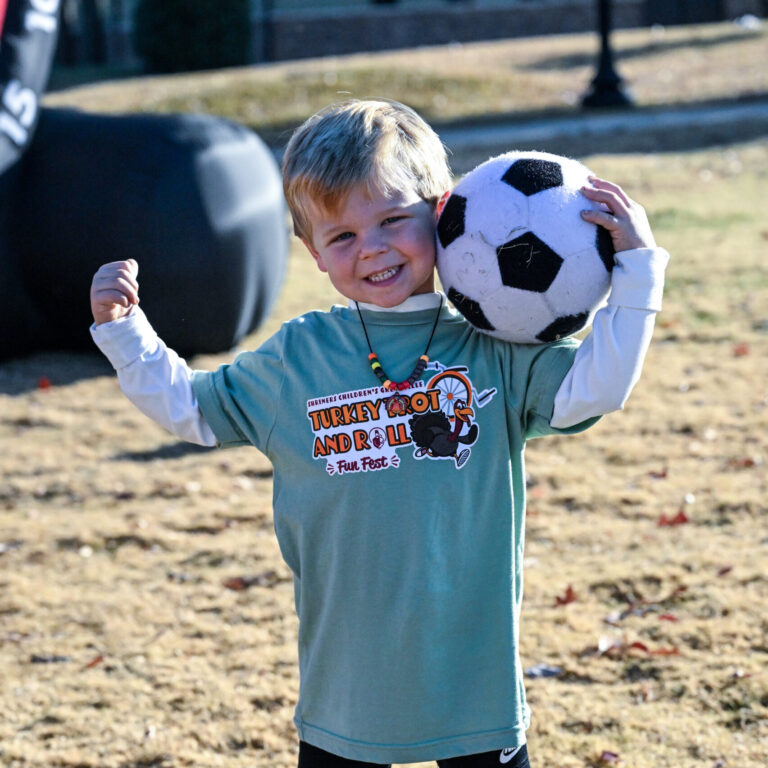 a child holding a soccer ball